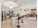 Bright kitchen with stainless appliances, stone backsplash, island with bar seating, and a built-in bar and dining space at 6612 Butlers Crest Dr, Bradenton, FL 34203