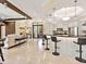 Open kitchen with a bar, island with bar seating, and view of the living room at 6612 Butlers Crest Dr, Bradenton, FL 34203