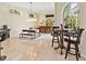 Bright living area with bar, travertine floors, dining table and views of the outside swimming pool at 6612 Butlers Crest Dr, Bradenton, FL 34203