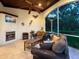 Cozy covered outdoor living room with fireplace, comfortable seating, and views of the private backyard at 6612 Butlers Crest Dr, Bradenton, FL 34203