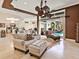 Open concept living room with view of kitchen and backyard pool, complete with stylish furnishings at 6612 Butlers Crest Dr, Bradenton, FL 34203