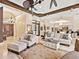 Expansive living room with tray ceiling, ceiling fans, neutral decor, and elegant furnishings at 6612 Butlers Crest Dr, Bradenton, FL 34203
