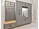 Mudroom features gray cabinets and a wood bench, offering both storage and a place to sit at 6612 Butlers Crest Dr, Bradenton, FL 34203