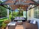 Charming covered patio with comfortable seating, a ceiling fan, and views of the landscaped backyard at 6612 Butlers Crest Dr, Bradenton, FL 34203