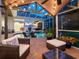 Expansive outdoor living space with a covered patio, screened-in pool, and ample seating for entertaining guests at 6612 Butlers Crest Dr, Bradenton, FL 34203