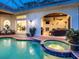 Beautiful backyard oasis with a pool, spa, covered living area, and outdoor kitchen for entertaining at 6612 Butlers Crest Dr, Bradenton, FL 34203