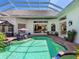 Inviting outdoor pool area with clear enclosure, comfortable seating, and views of interior living spaces at 6612 Butlers Crest Dr, Bradenton, FL 34203