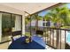 The unit's balcony has a table with seating, overlooks lush landscaping, and has direct access to the unit at 7201 Curtiss Ave # 2D, Sarasota, FL 34231