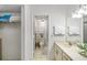 Bright bathroom featuring an open walkway to a tiled shower at 7201 Curtiss Ave # 2D, Sarasota, FL 34231