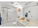 Bright bathroom with a shower, toilet, and mirror at 7201 Curtiss Ave # 2D, Sarasota, FL 34231