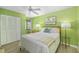 Bright bedroom with a ceiling fan and a comfortable bed at 7201 Curtiss Ave # 2D, Sarasota, FL 34231