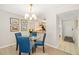 Cozy dining area with stylish blue chairs and adjacent kitchen view at 7201 Curtiss Ave # 2D, Sarasota, FL 34231