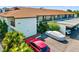 Exterior view of the community building, highlighting parking and landscaping at 7201 Curtiss Ave # 2D, Sarasota, FL 34231