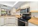 Well-lit kitchen featuring updated appliances and light countertops at 7201 Curtiss Ave # 2D, Sarasota, FL 34231