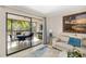 The living room opens to a screened-in porch and features comfortable seating and stylish decor at 7201 Curtiss Ave # 2D, Sarasota, FL 34231