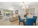 Bright living room with ceiling fan and glass doors to a balcony with outdoor seating at 7201 Curtiss Ave # 2D, Sarasota, FL 34231