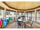 Relaxing covered patio area with comfortable seating, table, and a view of the community pool, great for entertaining at 7201 Curtiss Ave # 2D, Sarasota, FL 34231