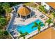 Aerial view of the community pool with surrounding lounge area and gazebo at 7201 Curtiss Ave # 2D, Sarasota, FL 34231