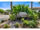 Community sign for The Crossings with lush landscaping and clear address markers at 7201 Curtiss Ave # 2D, Sarasota, FL 34231