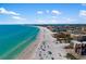 An aerial view of a pristine beach with turquoise water, hotels, and beachfront properties at 7203 Curtiss Ave # 3D, Sarasota, FL 34231