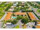 Aerial view of the condo complex, showing the pool, landscaping and nearby road and pond at 7203 Curtiss Ave # 3D, Sarasota, FL 34231