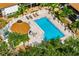 Aerial view of a refreshing community pool with a gazebo and lounge area at 7203 Curtiss Ave # 3D, Sarasota, FL 34231