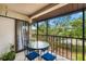 Cozy balcony with seating area and views of lush green trees at 7203 Curtiss Ave # 3D, Sarasota, FL 34231