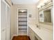 Well-lit bathroom featuring vanity with modern lighting and walk-in shower with striped curtain at 7203 Curtiss Ave # 3D, Sarasota, FL 34231