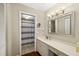 Well-lit bathroom featuring vanity with modern lighting and walk-in shower with striped curtain at 7203 Curtiss Ave # 3D, Sarasota, FL 34231