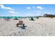 A vibrant beach scene featuring white sand, umbrellas, and people enjoying a sunny day at 7203 Curtiss Ave # 3D, Sarasota, FL 34231