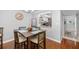 Dining room with wood floors, stylish table set, and view to kitchen area at 7203 Curtiss Ave # 3D, Sarasota, FL 34231