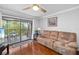 Comfortable living room with wood floors, slider to balcony, and stylish decor create a warm ambiance at 7203 Curtiss Ave # 3D, Sarasota, FL 34231