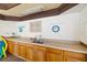 Pool area kitchenette featuring wood cabinets, sink, and updated countertops in a well-lit area at 7203 Curtiss Ave # 3D, Sarasota, FL 34231