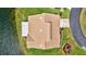 Bird's eye view showing the roof, driveway and lakeside yard of a single Gathering home at 75 Inlets Blvd # 75, Nokomis, FL 34275