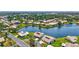 Beautiful aerial view of waterfront homes in a lush, green community with mature trees and well-maintained landscaping at 75 Inlets Blvd # 75, Nokomis, FL 34275