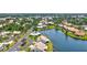 Gorgeous aerial shot showcasing homes nestled around a serene lake in a vibrant community with lush greenery at 75 Inlets Blvd # 75, Nokomis, FL 34275