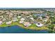 An aerial view of a lakeside neighborhood with single Gathering homes and lush greenery at 75 Inlets Blvd # 75, Nokomis, FL 34275