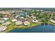 Stunning aerial view of a lakeside home nestled in a charming neighborhood with lush landscaping at 75 Inlets Blvd # 75, Nokomis, FL 34275
