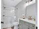 Bathroom with a glass-enclosed shower and single vanity with grey cabinets at 75 Inlets Blvd # 75, Nokomis, FL 34275