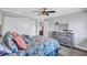 Comfortable bedroom featuring a ceiling fan, closet, and decorative dresser with mirror at 75 Inlets Blvd # 75, Nokomis, FL 34275