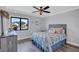 Bedroom with a ceiling fan, laminate flooring, and view of the neighborhood at 75 Inlets Blvd # 75, Nokomis, FL 34275