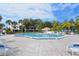 Beautiful community pool area with clear blue water and lounge chairs under a sunny sky at 75 Inlets Blvd # 75, Nokomis, FL 34275