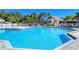 Inviting community pool surrounded by lush tropical landscaping and comfortable lounge chairs at 75 Inlets Blvd # 75, Nokomis, FL 34275
