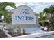 Entrance sign to The Inlets community with lush tropical landscaping and decorative stone at 75 Inlets Blvd # 75, Nokomis, FL 34275