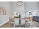 Bright dining area offers a chandelier, high ceilings, and ample space at 75 Inlets Blvd # 75, Nokomis, FL 34275