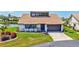 Well-maintained home exterior with lush landscaping and a tile roof at 75 Inlets Blvd # 75, Nokomis, FL 34275