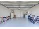 Spacious garage with epoxy flooring and ample storage, including a motorcycle and bicycle at 75 Inlets Blvd # 75, Nokomis, FL 34275