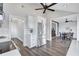 Modern kitchen open to a dining area with stainless steel refrigerator and grey wood floors at 75 Inlets Blvd # 75, Nokomis, FL 34275