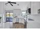 Bright kitchen with stainless appliances and a view of a screened-in patio with lake views at 75 Inlets Blvd # 75, Nokomis, FL 34275