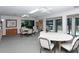 Community library with tables, chairs, and bookshelves, offering a cozy space to read and relax at 75 Inlets Blvd # 75, Nokomis, FL 34275